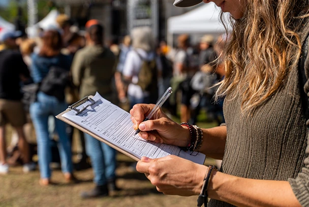 person filling out a survey for event