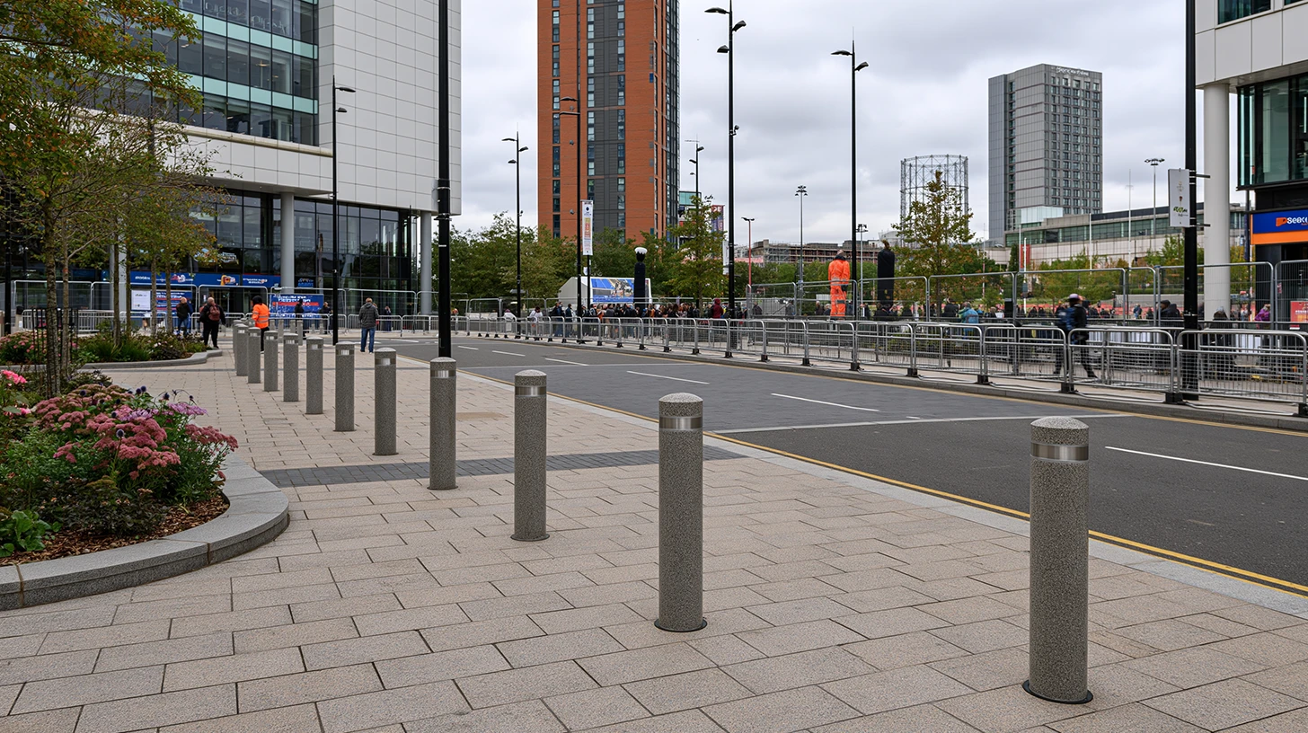 Row of PAS 68 rated hostile vehicle mitigation bollards protecting a pedestrian event entrance with standoff distance